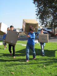 students carrying boxes